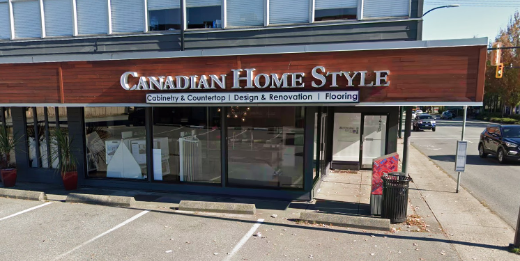 Street view of a storefront called "Canadian Home Style," offering cabinetry, countertops, design, renovation, and flooring services, with parking spaces in front.